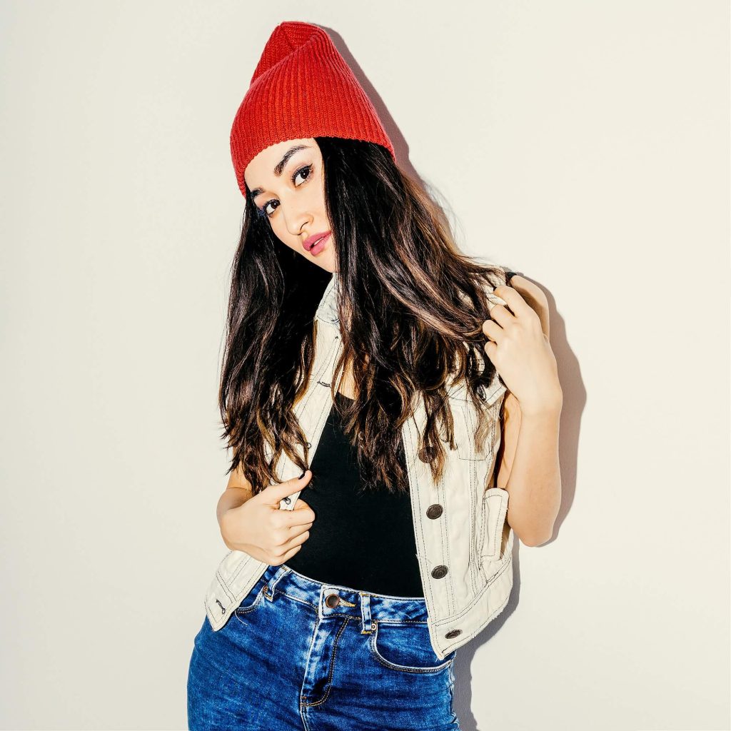 brunette model in fashion beanie cap and jeans urban casual sty 1